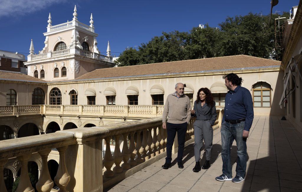 Teresa Vicente walks at the University of Murcia with two fellow lawyers